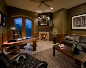 home office with black sofa and fireplace