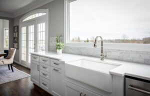 white kitchen farm sink in remodeled kitchen